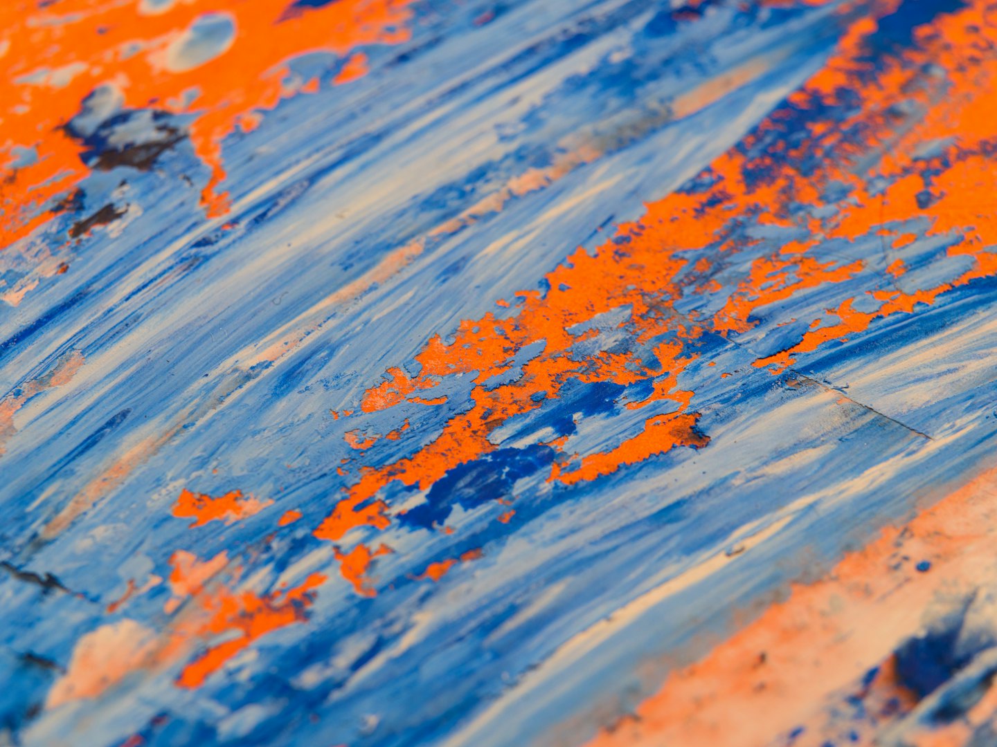 Textured blue and white paint strokes on an orange background.
